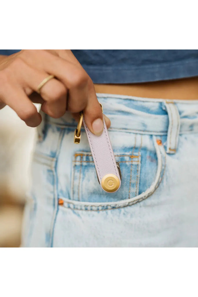 Orbitkey Leather Key Organiser Saffiano Leather Lilac being slipped into a front jeans pocket