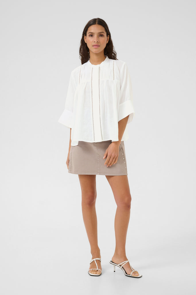 Person wearing a white blouse and taupe skirt.Karen by Simonsen Vilde Blouse bright white.