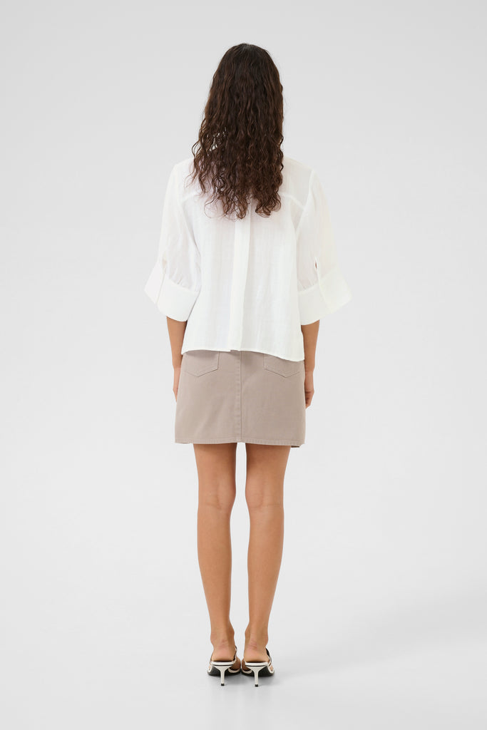 Person wearing a white blouse and taupe skirt.Karen by Simonsen Vilde Blouse bright white.