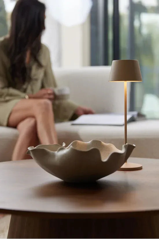 Ned Collection Bluff Ceramic bowl on a table with a person sitting in the background