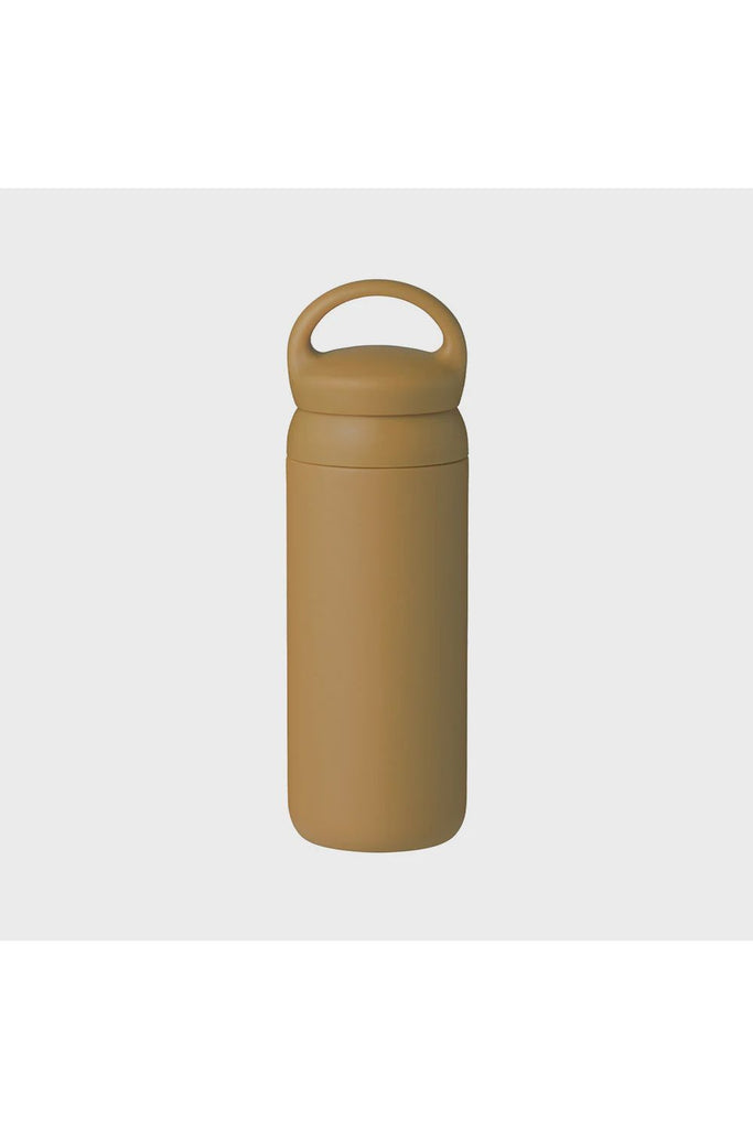 Kinto Day Off Tumbler in Mustard Yellow. An insulated tumbler with a handle on a light grey background.