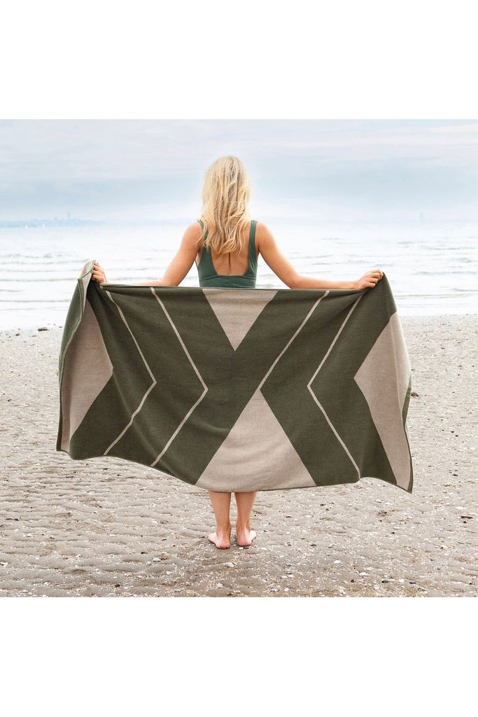 & Sunday Organic Cotton Ranger Pool Towel Beach Towel  Fern Green and Cream Diagonal Pattern Model Standing facing water holding towel opened up across her back