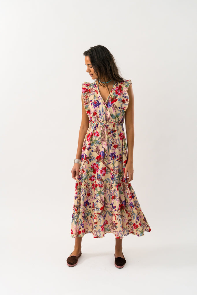 Woman wearing a floral dress on a white background. Lollys Laundry Samo Midi Dress in Flower Print.