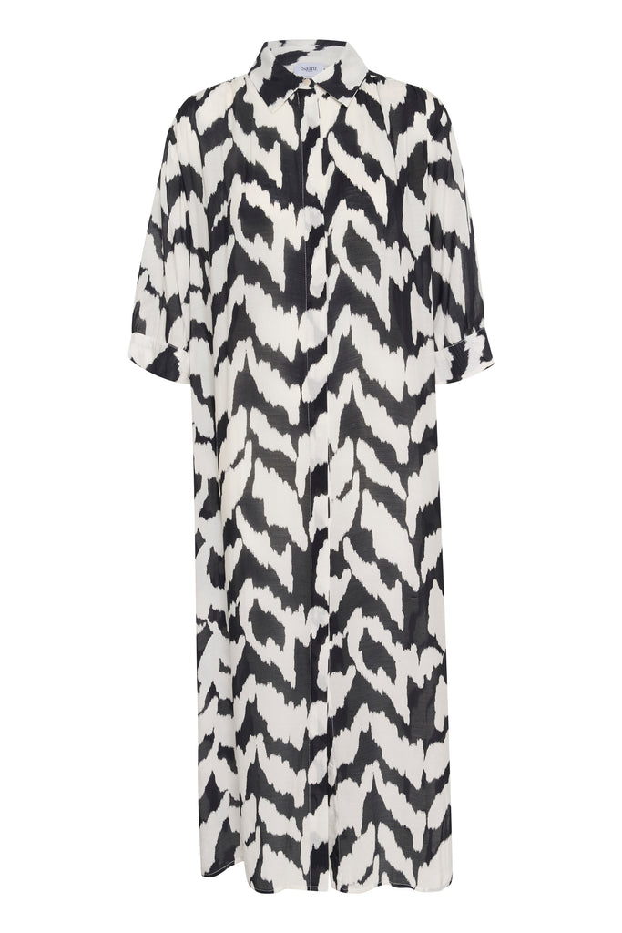 Black and white patterned dress on a plain background. Saint Tropez Kelsie Shirt dress in black and white.