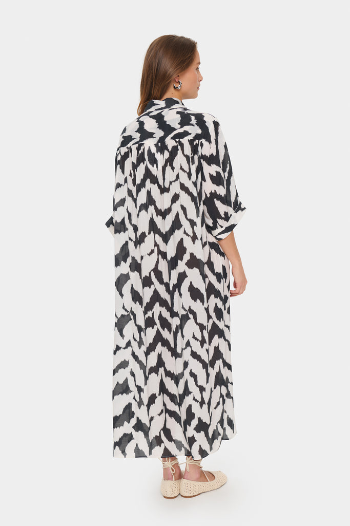 Black and white patterned dress worn by a person on a plain background. Saint Tropez Kelsie Shirt dress in black and white.