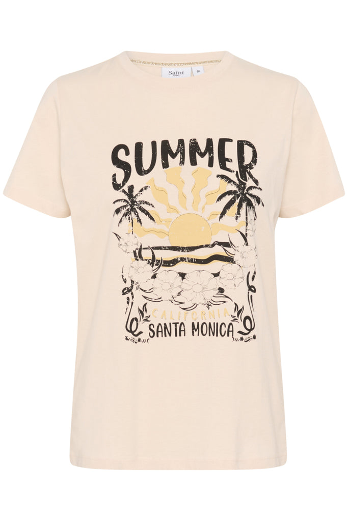 Woman wearing a 'Summer Santa Monica' t-shirt with a graphic design. Saint Tropez Kuvi Tee