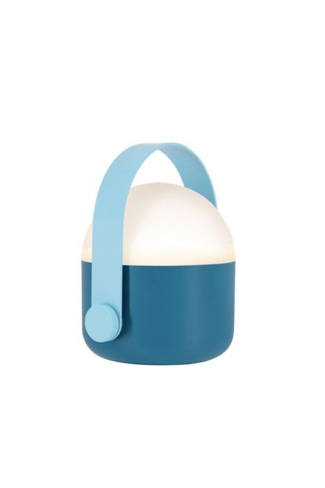 Blue Remember Ole portable LED lamp with handle, softly glowing in warm white light, shown standing on a flat surface.