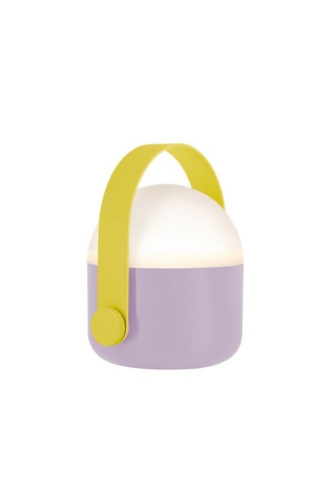 Lilac Remember Ole portable LED lamp with a bright yellow handle, softly glowing in warm white light on a flat surface.