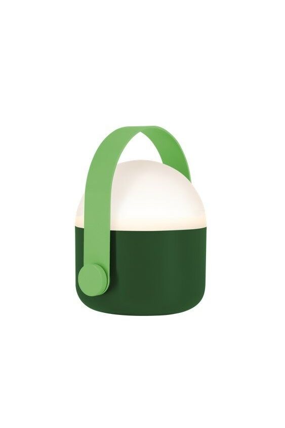 Green Remember Ole portable LED lamp with handle, softly glowing in warm white light, shown standing on a flat surface.