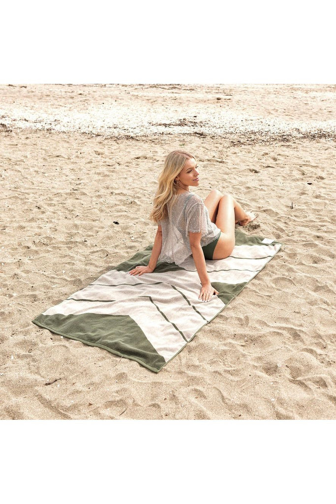 & Sunday Organic Cotton Ranger Pool Towel Beach Towel  Fern Green and Cream Diagonal Pattern Model sitting on Towel on Beach
