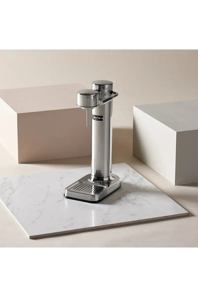 Chrome Aarke Soda Carbonator three on a marble countertop with a neutral background