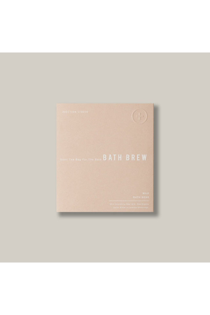 Addition Studio Giant Tea Bag for the Bath: Brew Milk Bath Soak. Beige package of Bath Brew on a light grey background.