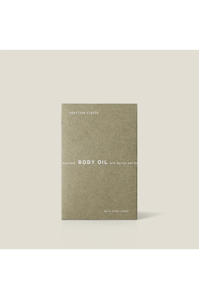 Addition Studio Body oil packaging with 'Addition Studio' branding on a beige background.