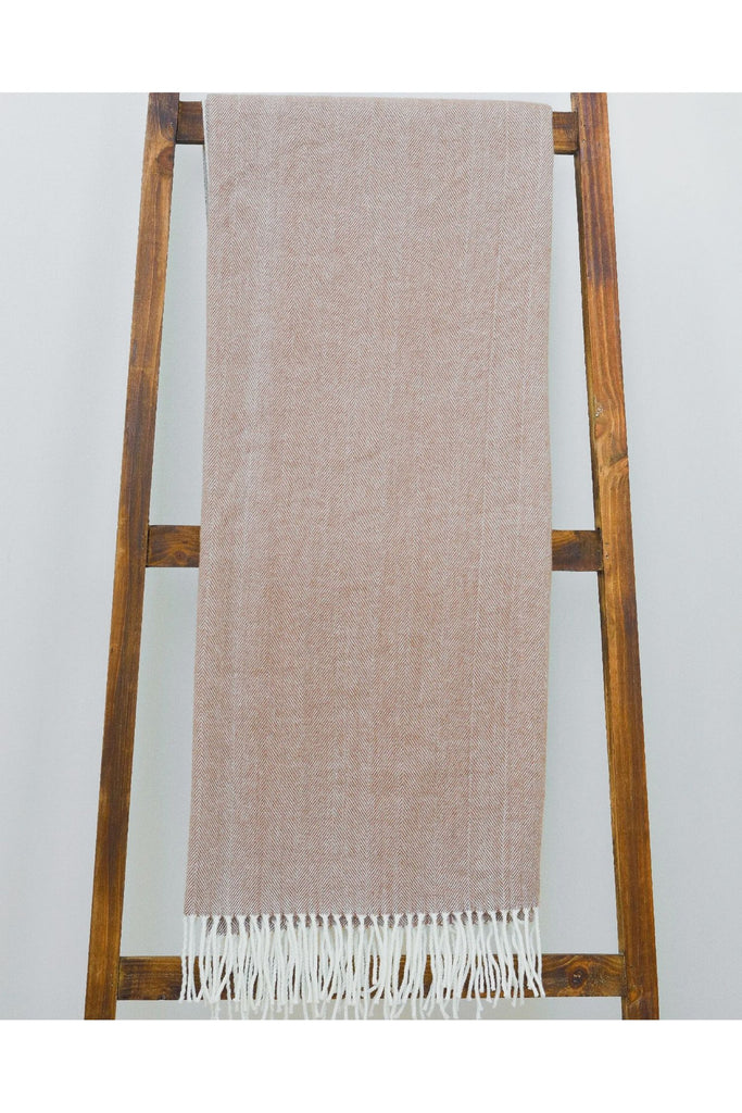 Alashan-Cotton-Acrylic-Adirondack-Herringbone-Woven-Throw-in-Toffee--Throw-draped-over-a-wooden-ladder