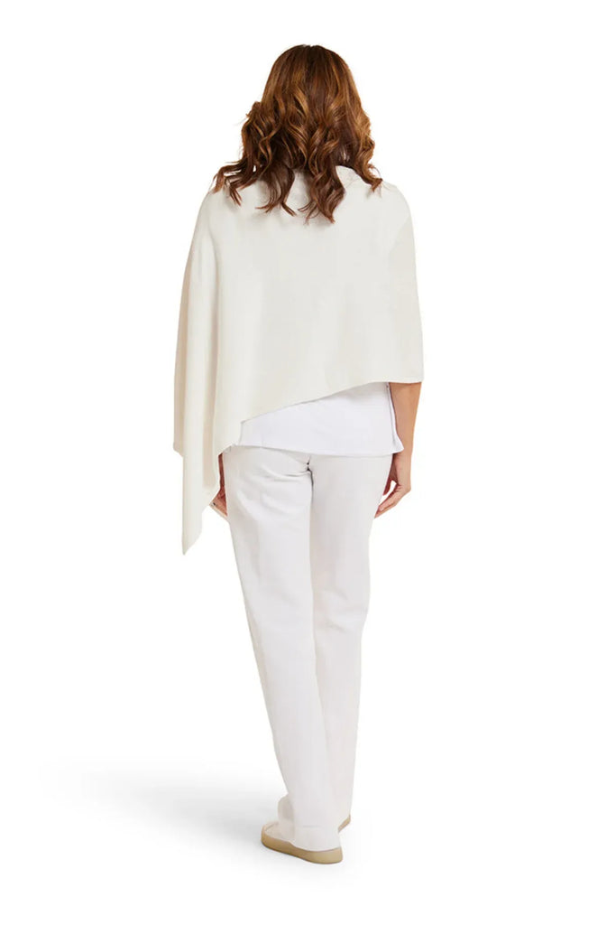 Woman wearing a white shawl over a white top and pants on a white background. Alashan Cotton Cashmere Topper in Off White.