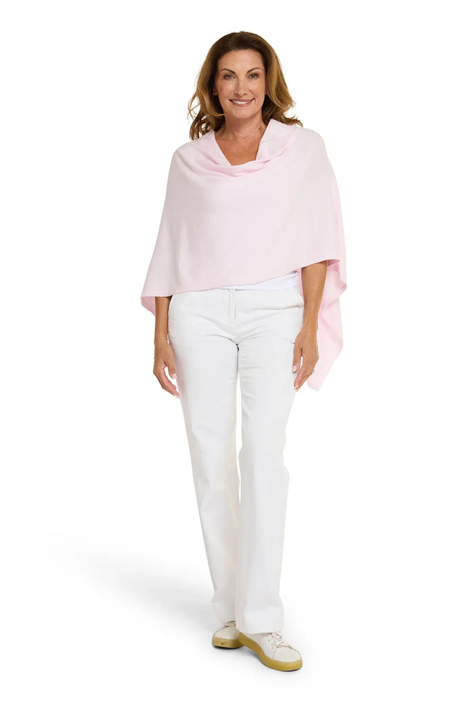 Woman wearing a light pink top and white pants on a white background. Alashan Cotton Cashmere Topper in Pink Sugar.
