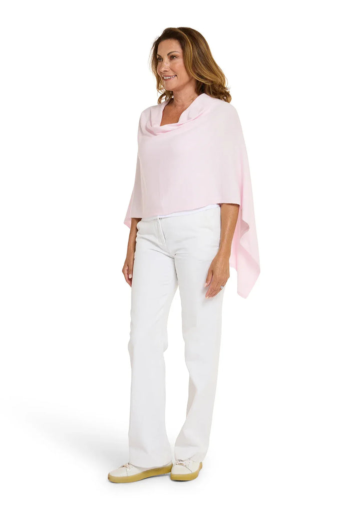Woman wearing a light pink top and white pants on a white background. Alashan Cotton Cashmere Topper in Pink Sugar.