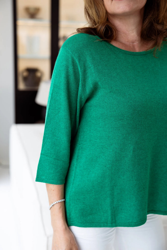 Woman in a green sweater. Alashan Everyday Tee in Emerald Green.