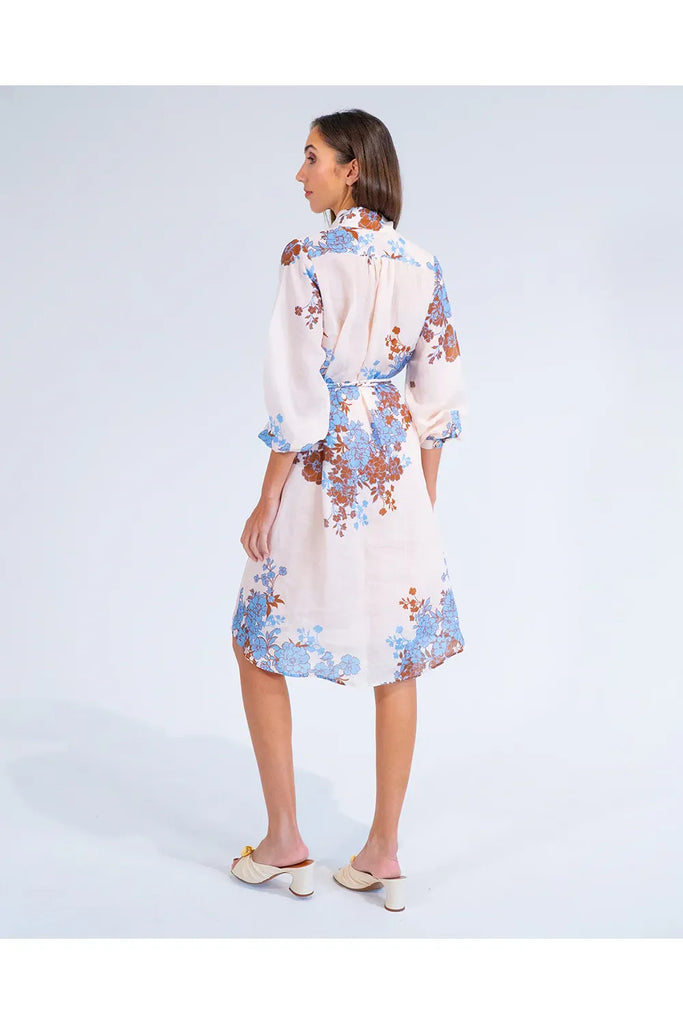 Woman wearing a floral dress on a white background. Arlington Milne Emerson Dress in Wisley Floral.