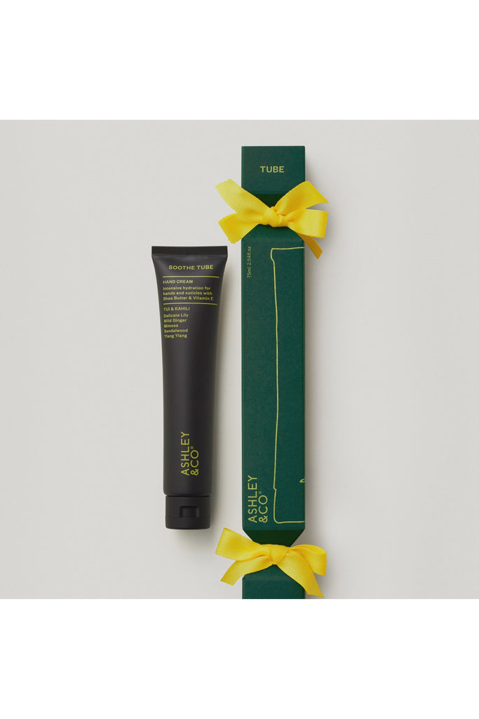 Ashley & Co Forest Collection Soothe Tube Tui & Kahili. Tube of handcream with green packaging and yellow ribbon on a light grey background.