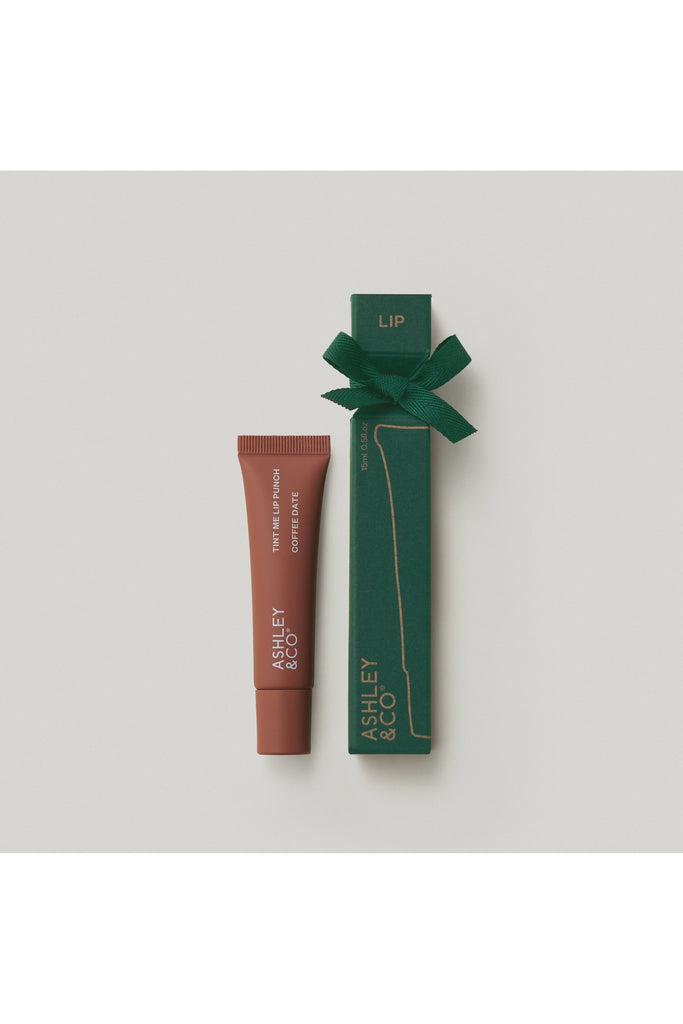 Ashley & Co Forest Collection Tint Me Lip Punch Coffee Date. Lip tint tube and green packaging with 'Ashley & Co' branding on a light grey background.
