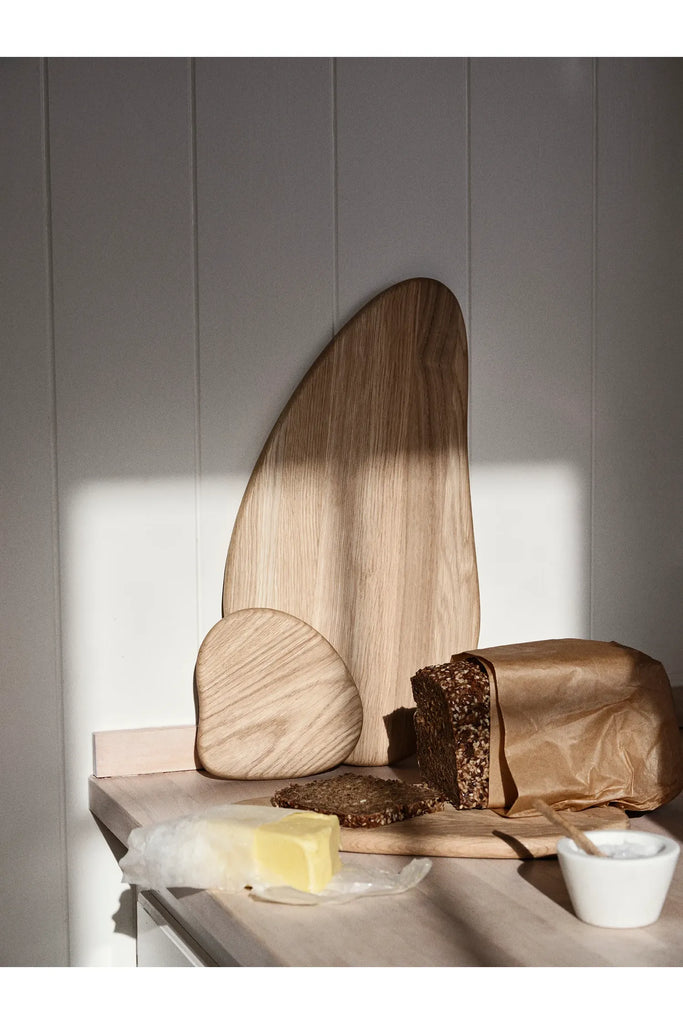 Broste Natural Limfjord Board Large. Cutting board with bread and butter on a kitchen counter