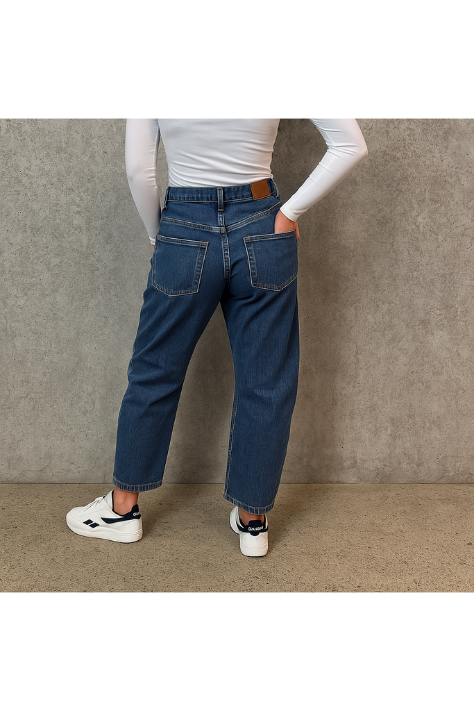 Person wearing dark blue jeans and white sneakers on a plain background. LTB Marlow Barrel Jean in Sadira wash.