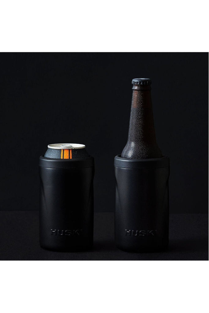 Two black Husky beer coolers, one holding a can and the other with a bottle inside, on a black background.