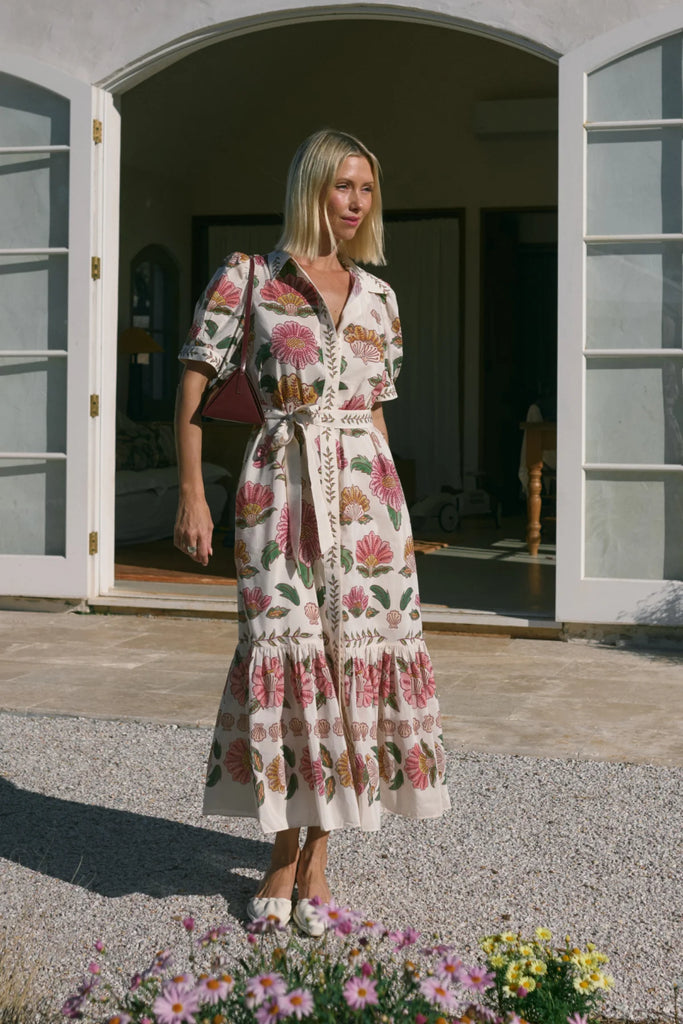 Woman wearing a floral dress on a white background. Cable Melbourne Evita dress in Rosa Floral.