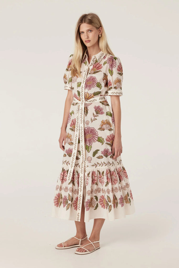 Woman wearing a floral dress on a white background. Cable Melbourne Evita dress in Rosa Floral.