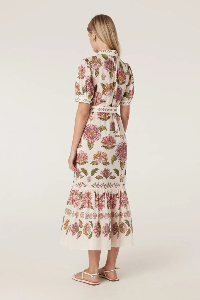 Woman wearing a floral dress on a white background. Cable Melbourne Evita dress in Rosa Floral.