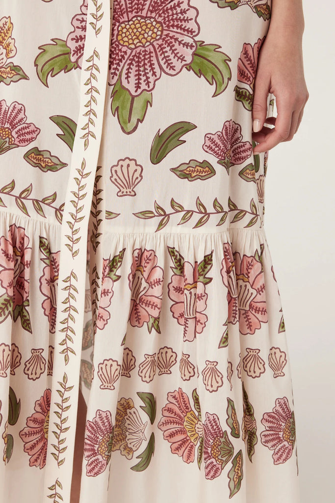 Woman wearing a floral dress on a white background. Cable Melbourne Evita dress in Rosa Floral.