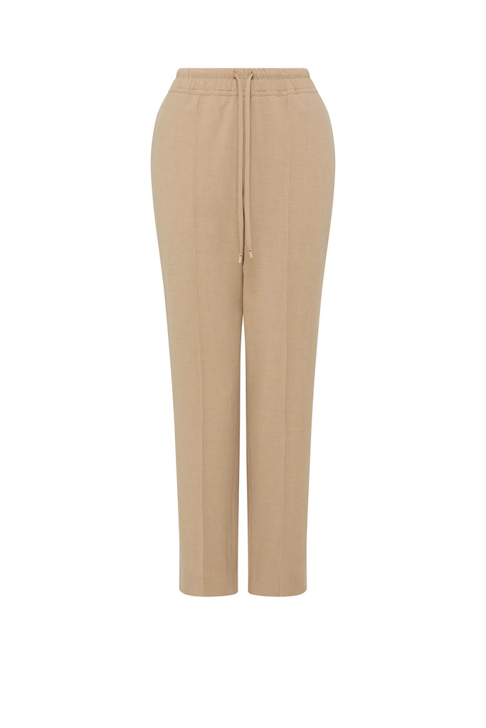 Person wearing beige pants with a white background. Cable Pierre Pant in Light Camel.