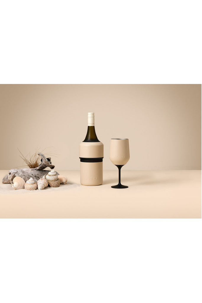 Huski Coastal Collection Sand Beige Wine Cooler and Wine Tumbler. Wine bottle in wine cooler, sitting next to wine tumbler with decorative elements on a beige background.