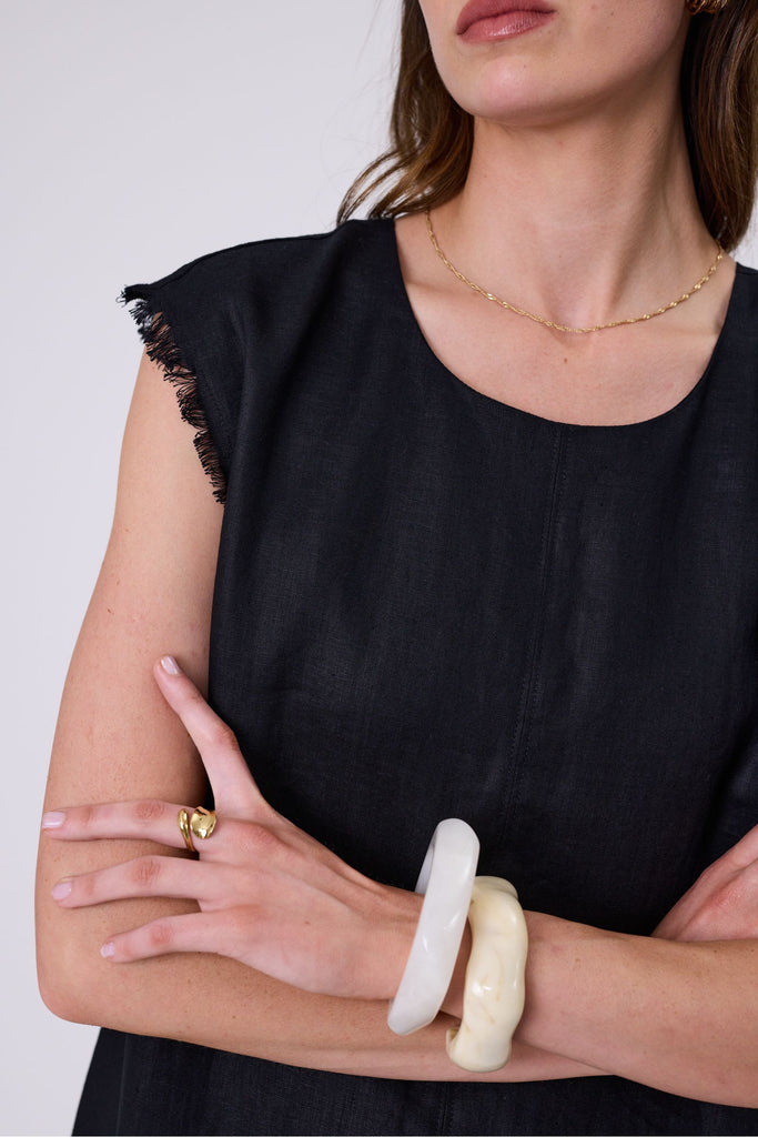 Woman wearing a black dress on a white background. Marlow Costa Linen dress in Black.