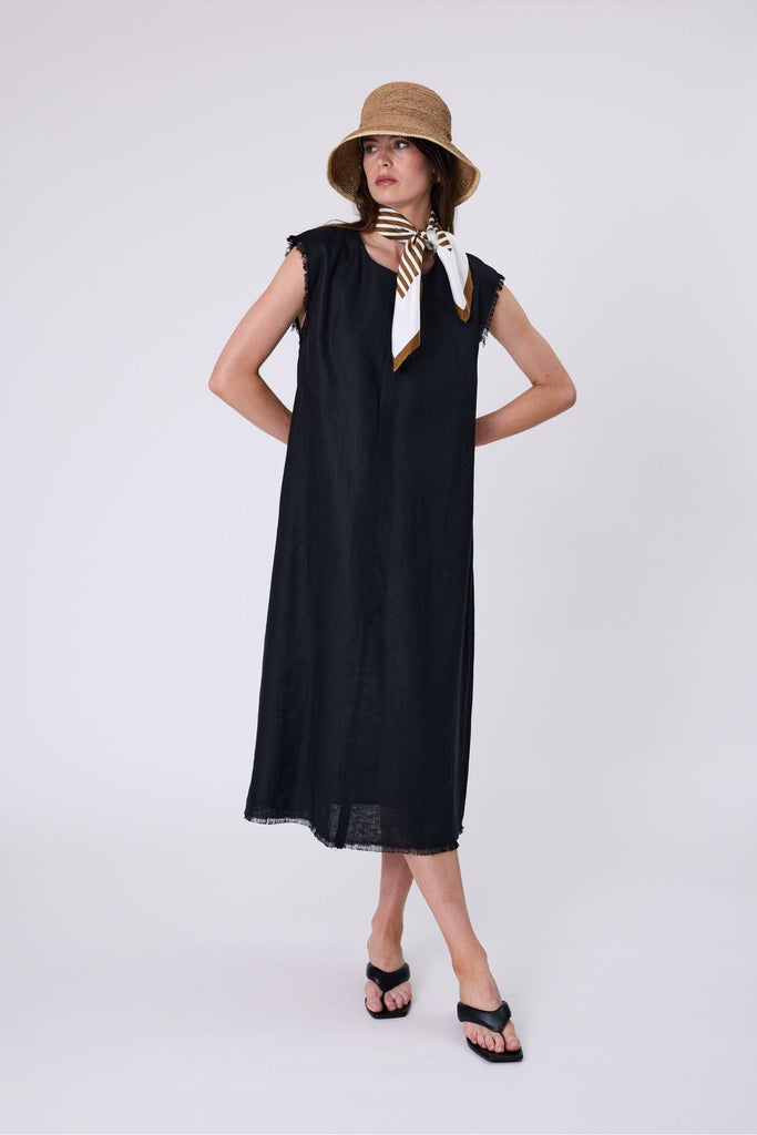 Woman wearing a black dress on a white background. Marlow Costa Linen dress in Black.