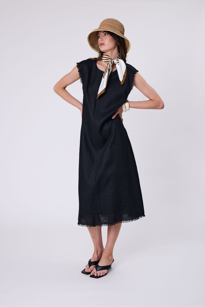 Woman wearing a black dress on a white background. Marlow Costa Linen dress in Black.