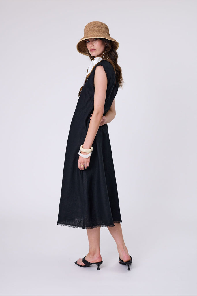 Woman wearing a black dress on a white background. Marlow Costa Linen dress in Black.
