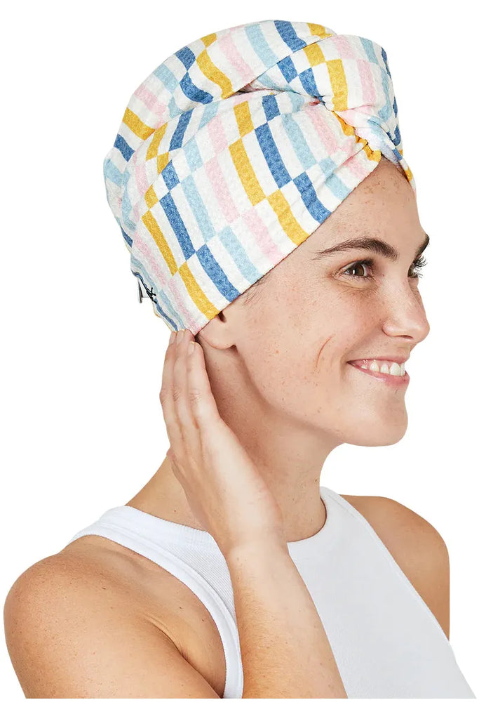 Image of Boardwalk Waffle Hair Wrap on model.  Image taken side on.. Hairwrap has small coloured stripe blocks in yellow, blue, pale blue and pale pink