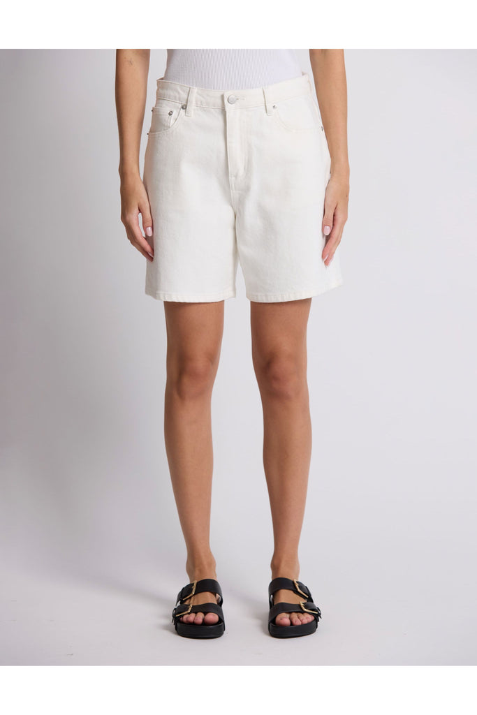 Person wearing white shorts on a plain background. Stella and Gemma White Denim Emily Shorts.