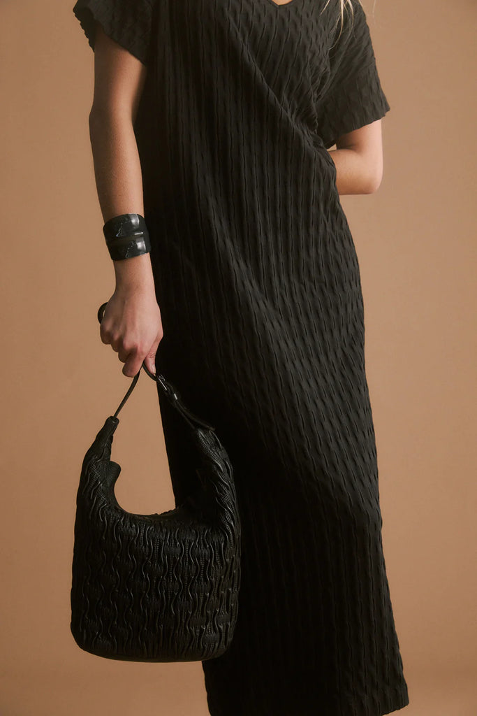 Woman wearing a black dress on a white background. Elk Orta Dress Black,