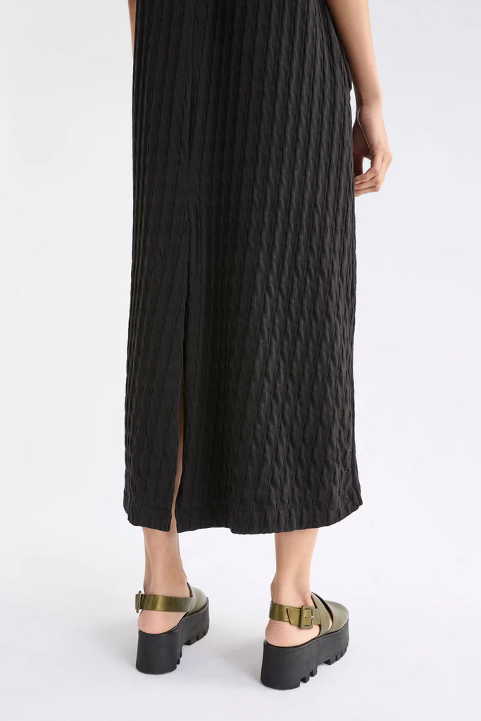 Woman wearing a black dress on a white background. Elk Orta Dress Black,