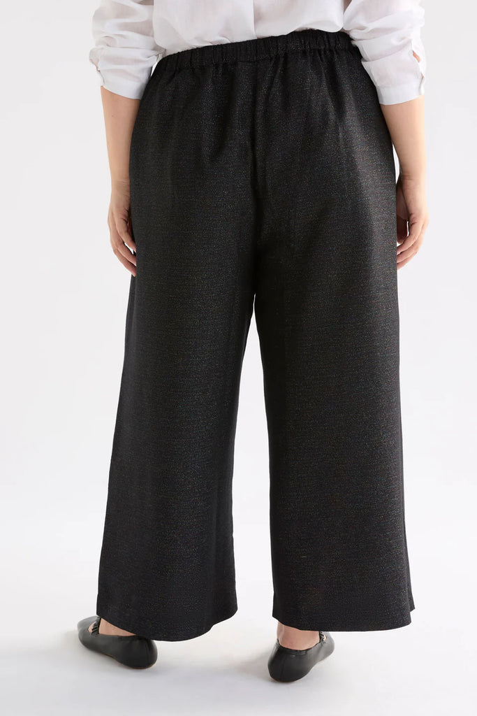 Person wearing a black sparkly outfit against a white background. Elk Tulle Pant.