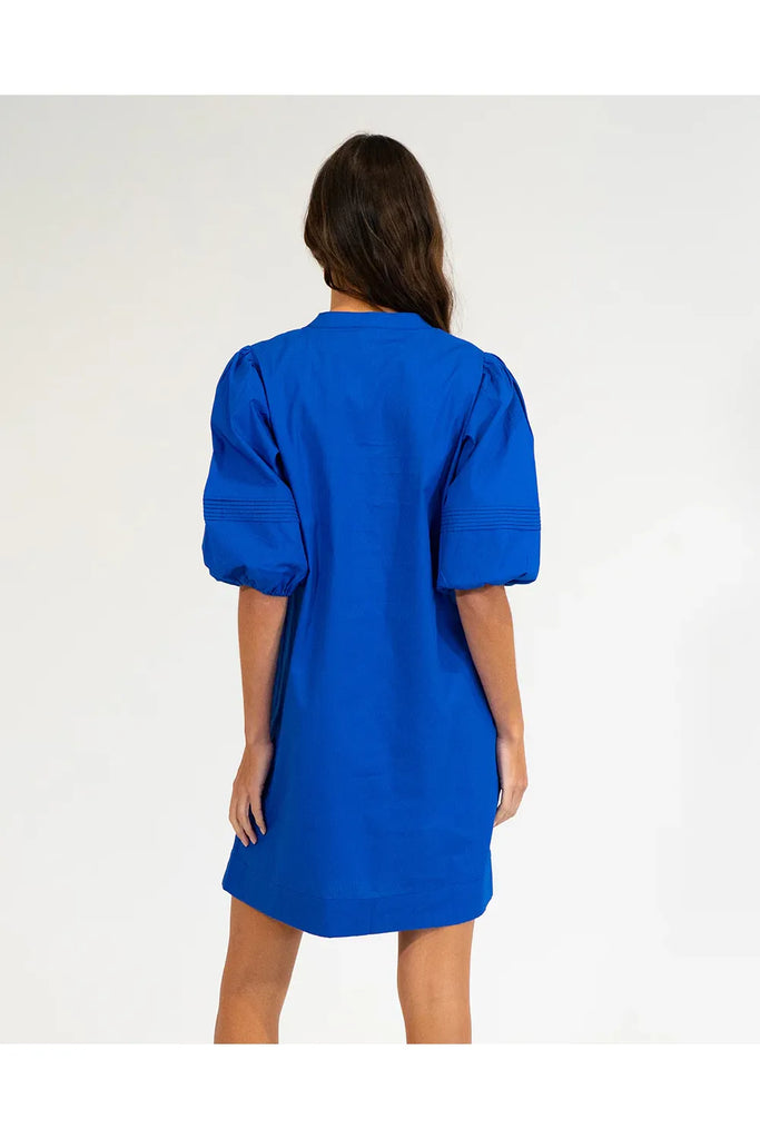 Woman wearing a cobalt blue dress on a white background. Elms & King Monterey Mini Dress in Cobalt Blue.