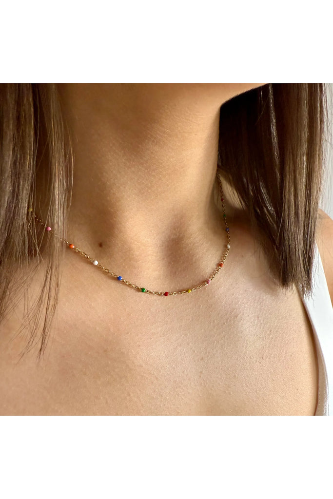 Necklace with multicolored beads worn by a person with shoulder-length hair. Ever Colour Wave Necklace.