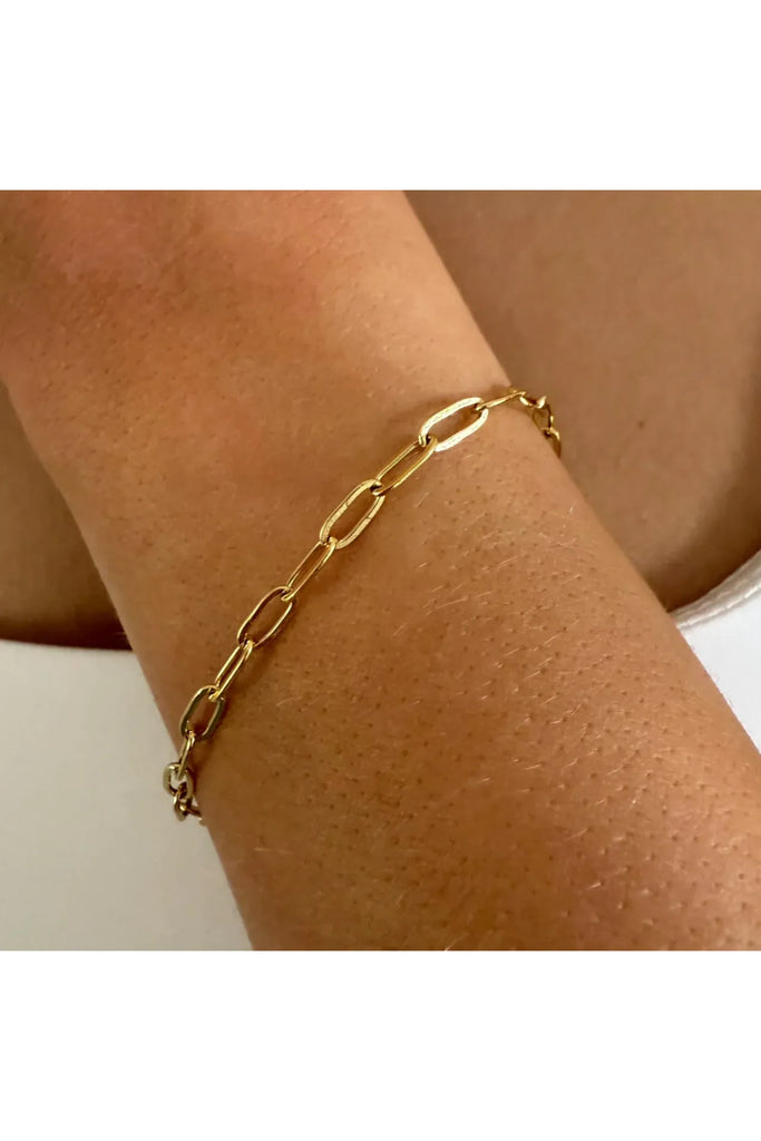 Gold chain bracelet on a wrist against a neutral background. Ever Laneway Chain Bracelet Gold