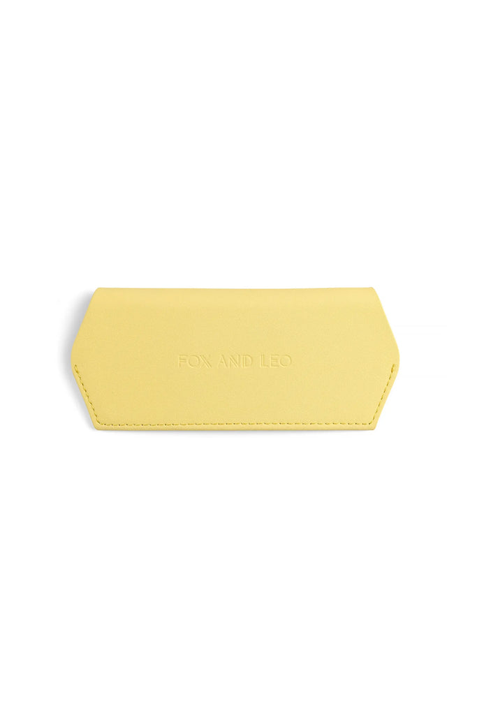Yellow sunglasses case with 'FOX AND LEO' branding on a white background