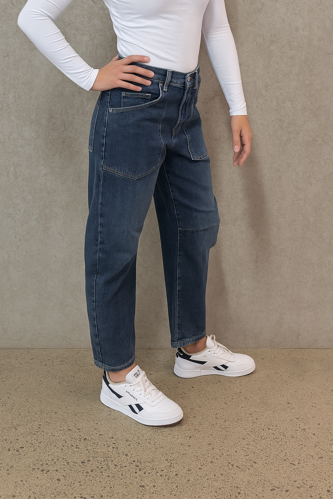 Person wearing dark blue jeans and white sneakers on a plain background. LTB Marlow Barrel Jean in Sadira wash.