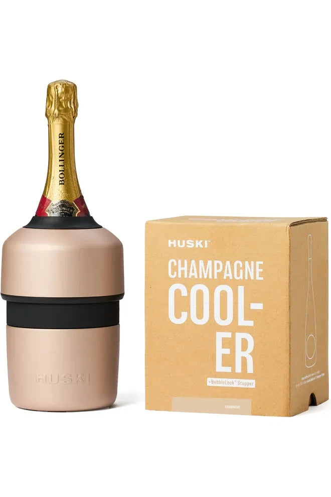 Huksi Champagne Cooler in Champagne Colourway standing with a Bottle of Bollinger in it, beside the kraft label packaging box it comes in.