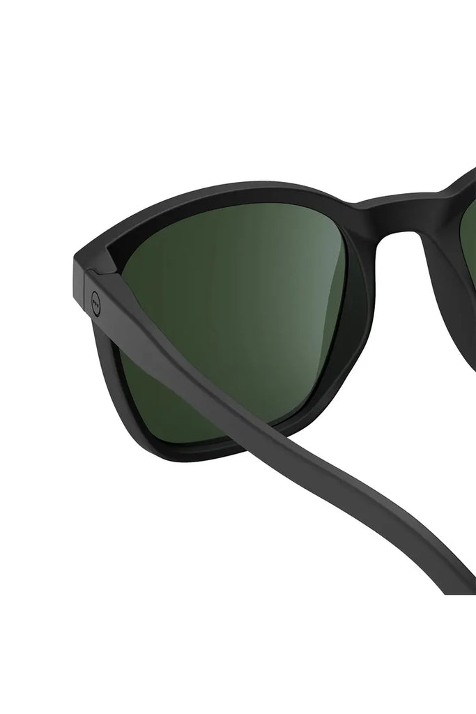 Izipizi polarised black sunglasses with green lenses on a white background.